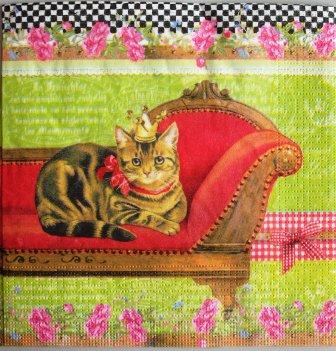 Chat couronné sur canapé rouge